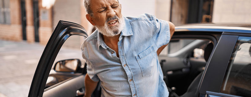 patient with back pain in need of auto accident injury care in New Braunfels