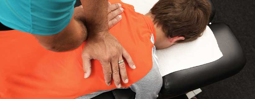 patient receiving drop table chiropractic in New Braunfels for auto accident injury pain relief